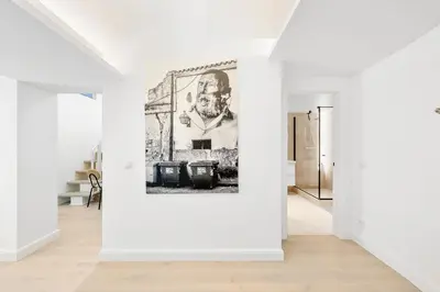 a white room with a painting on the wall at Elegant Apartments in Vilnius Center, 11 in Vilnius