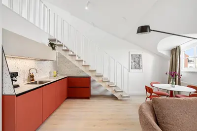 a kitchen and living room with a staircase at Elegant Apartments in Vilnius Center, 11 in Vilnius