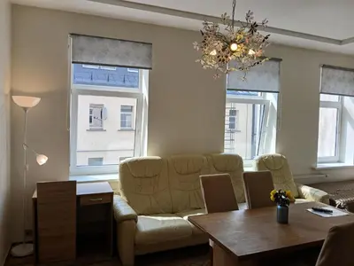 a living room with a couch and a table at Big apartment in city center in Kaunas
