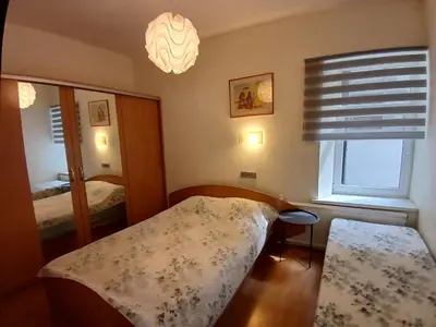 a small bedroom with a bed and a window at Big apartment in city center in Kaunas
