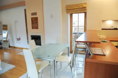 a kitchen with a table and chairs in a room at Rooftop Charm Stylish 2BDR Steps from Town Hall in Vilnius