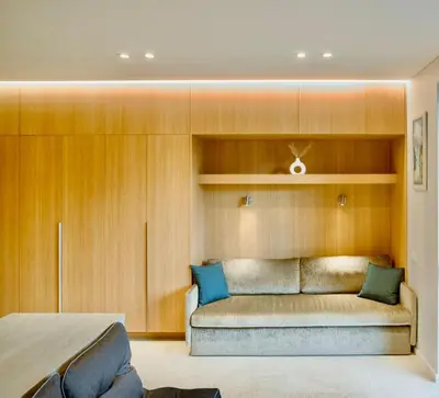 a couch in a room with wooden walls at Flat in Vlinius city center in Vilnius