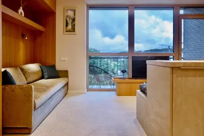 a living room with a couch and a large window at Flat in Vlinius city center in Vilnius