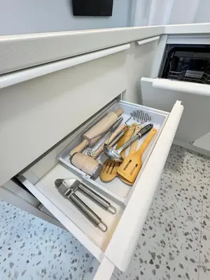 a drawer in a kitchen with a bunch of utensils at Bright white in Vilnius