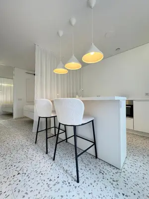 a dining room with a table and two chairs at Bright white in Vilnius