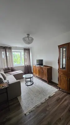a living room with a couch and a table at Virš miesto in Utena