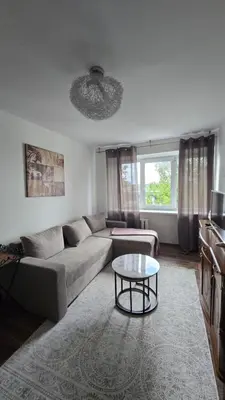 a living room with a couch and a table at Virš miesto in Utena