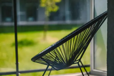 a black bench sitting in front of a window at Liv in Vilnius New town in Vilnius