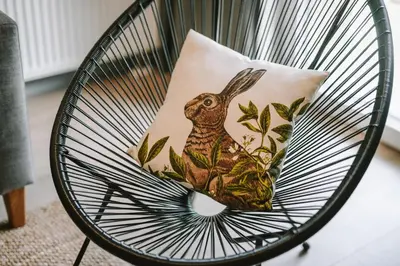 a chair with a pillow with a rabbit on it at Liv in Vilnius New town in Vilnius