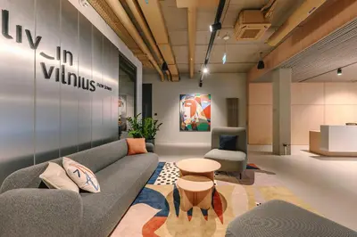 a living room with a couch and a chair at Liv in Vilnius New town in Vilnius