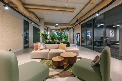 an office lobby with couches and a table at Liv in Vilnius New town in Vilnius