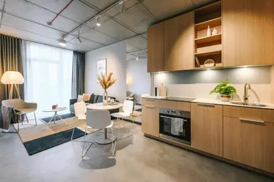a kitchen and living room with a table and chairs at Liv in Vilnius New town in Vilnius