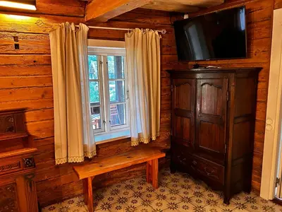 a living room with a tv and a window at Rustic Guesthouse in Pine Forest