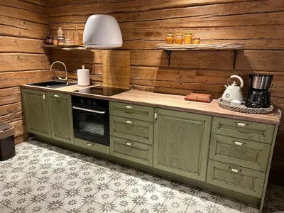 a kitchen with green cabinets and a stove at Rustic Guesthouse in Pine Forest