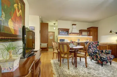 a kitchen and dining room with a table and chairs at Helios 19 Luxury Vilnius Apartment in Vilnius