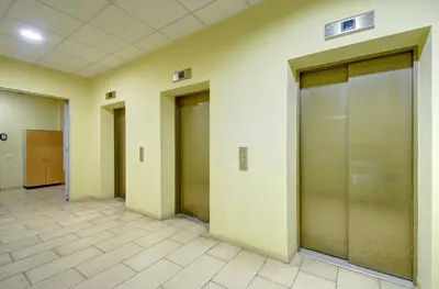 a row of elevator doors in a hallway at Helios 19 Luxury Vilnius Apartment in Vilnius