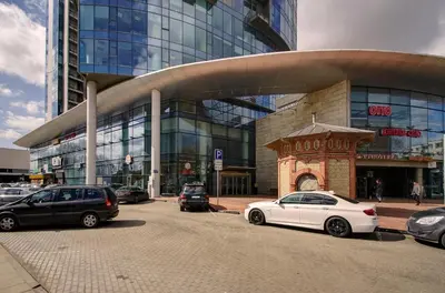 a white car parked in front of a building at Helios 19 Luxury Vilnius Apartment in Vilnius