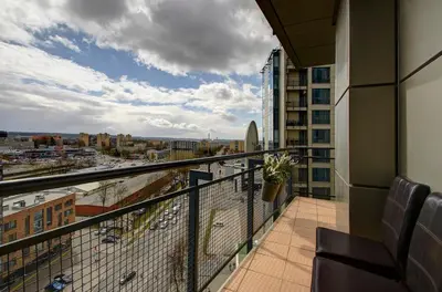 a balcony with a view of a city at Helios 19 Luxury Vilnius Apartment in Vilnius