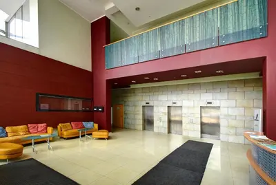 a lobby with couches and tables in a building at Helios 19 Luxury Vilnius Apartment in Vilnius