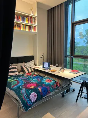 a bedroom with a desk and a bed with a blanket at Design apartment with view to Nemunas, Prienai in Pakopi