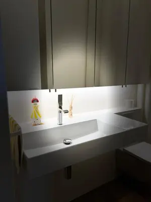 a bathroom with a white sink and a mirror at Design apartment with view to Nemunas, Prienai in Pakopi