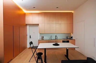 a kitchen with a table in the middle of a room at Design apartment with view to Nemunas, Prienai in Pakopi