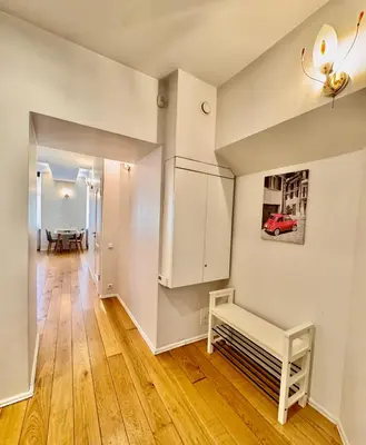 a living room with white walls and wooden floors at Old Town T8 SELF Check In in Vilnius