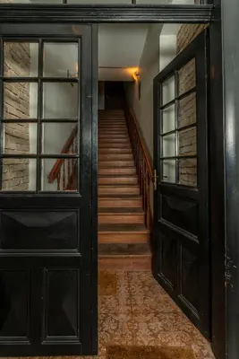 an open door to a hallway with a staircase at Old Town T8 SELF Check In in Vilnius