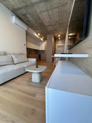 a living room with a couch and a table at Apartamentai prie Soboro in Kaunas