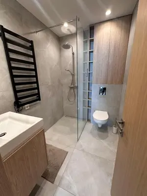 a bathroom with a shower and a toilet and a sink at Apartamentai prie Soboro in Kaunas