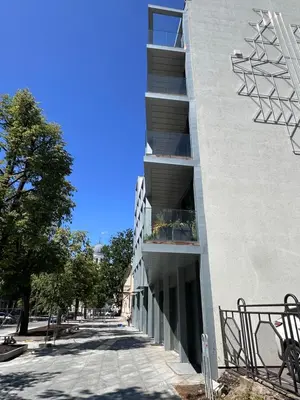 a building on a street with a blue sky at Apartamentai prie Soboro in Kaunas