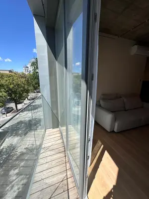 a glass extension to a house with a balcony at Apartamentai prie Soboro in Kaunas