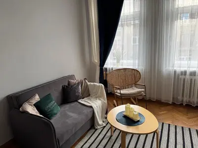 a living room with a couch and a table at Maironio g Centras in Kaunas