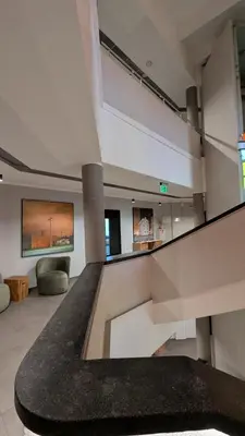 a large room with a staircase in a building at Stylish Private Room in Art Hotel Central Vilnius in Vilnius