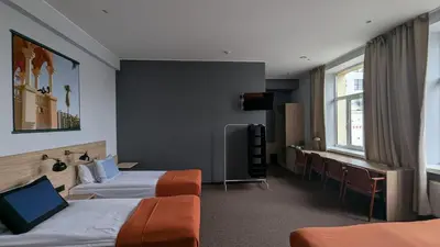 a hotel room with two beds and a desk at Stylish Private Room in Art Hotel Central Vilnius in Vilnius