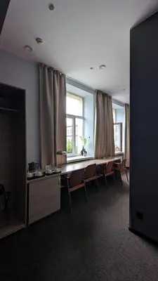 a room with a table and chairs and a window at Stylish Private Room in Art Hotel Central Vilnius in Vilnius