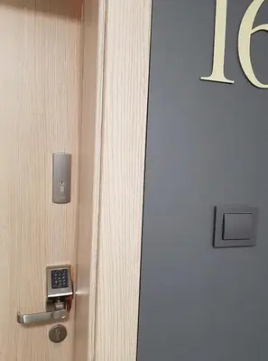 a door with a lock and a clock on it at Krivių Street Residential in Vilnius