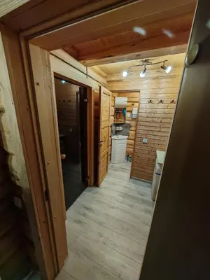 a hallway leading to a kitchen in a log cabin at Atokvėpis Alantos kaime in Alanta
