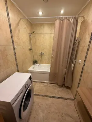 a bathroom with a washing machine and a shower at Seliu 29 in Vilnius