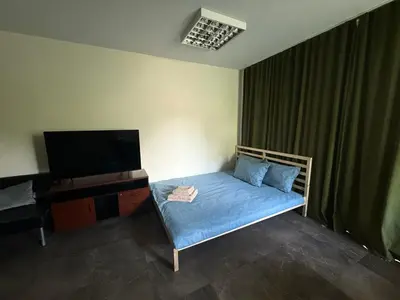 a small bedroom with a bed and a television at Seliu 29 in Vilnius