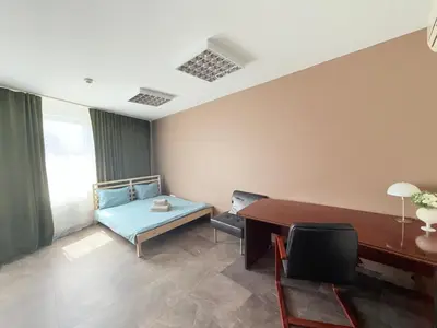 a room with a bed and a desk and a table at Seliu 29 in Vilnius