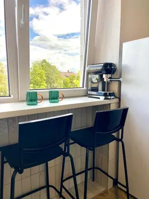 two blue chairs sitting at a counter with a window at Mens Cave in Šiauliai