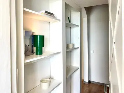 a room with white shelves and a green container at Mens Cave in Šiauliai
