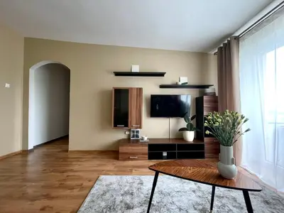 a living room with a table and a tv at Mens Cave in Šiauliai