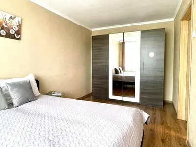 a bedroom with a white bed and a mirror at Mens Cave in Šiauliai