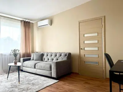 a living room with a couch and a door at Mens Cave in Šiauliai