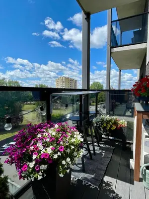a balcony with flowers and a table and chairs at Cashmere apartment in Žaliakalnis in Kaunas