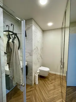 a bathroom with a shower and a toilet and a sink at Cashmere apartment in Žaliakalnis in Kaunas