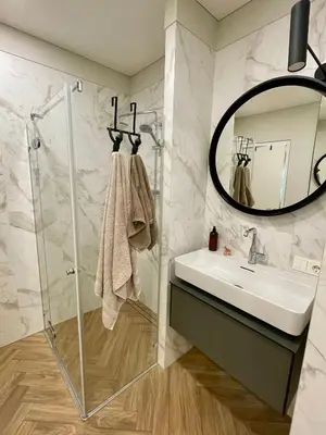 a bathroom with a sink and a mirror at Cashmere apartment in Žaliakalnis in Kaunas
