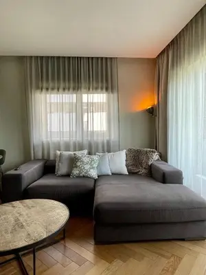 a living room with a couch and a table at Cashmere apartment in Žaliakalnis in Kaunas